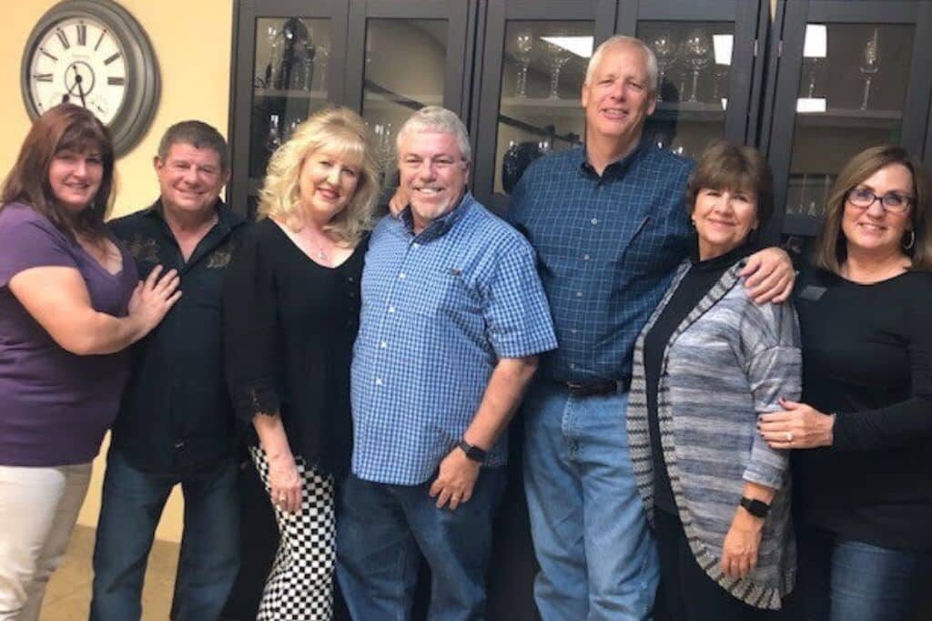 A group of UHSP alumni smile during an alumni event.