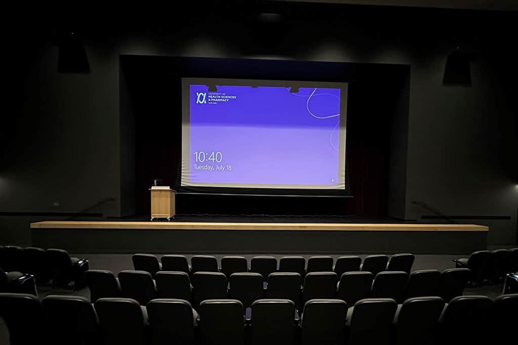 UHSP auditorium view of stage projector screen from audience